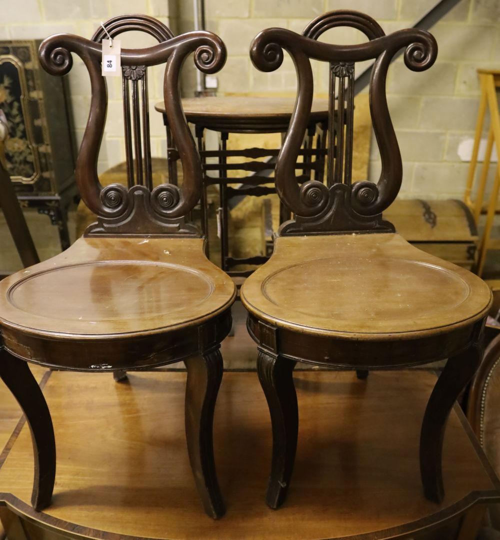 A pair of George IV style mahogany hall chairs